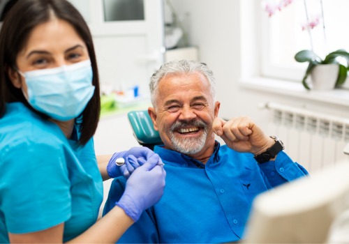 A happy man laughing as he receives Dental Care in Peoria IL