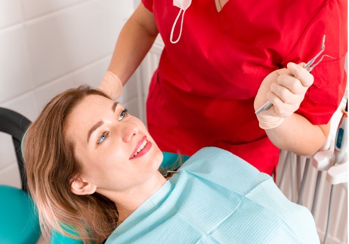 A woman is seen smiling during her teeth cleaning. River City Family Dentistry offers Teeth Cleaning in Dunlap IL.