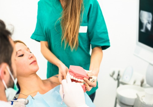 A woman is seen receiving information about her treatment during a dental visit. River City Family Dentistry provides partials and dentures in East Peoria IL.