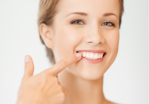 A woman smiles to display her whitened teeth. River City Family Dentistry offers teeth whitening in Dunlap IL.