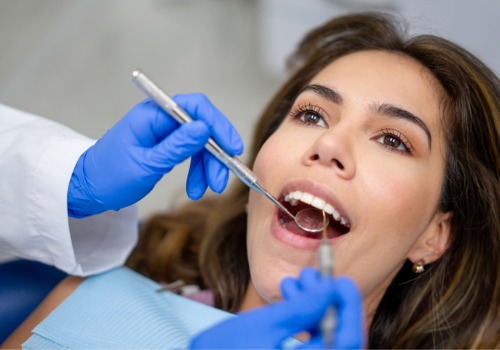 A woman smiles during a dental visit. River City Family Dentistry offers family dental care.