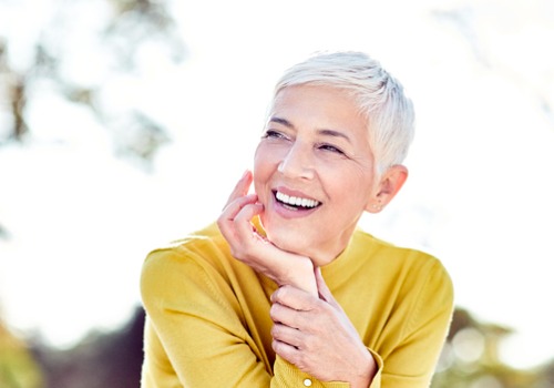 An older woman is seen smiling. River City Family Dentistry offers dentures.