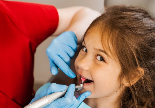 A patient smiles during a dental checkup. River City Family Dentistry is a dental office in Morton IL.